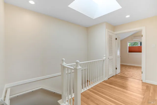 a view of a hallway with wooden floor