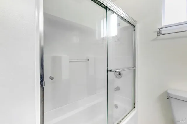 a bathroom with a glass shower door