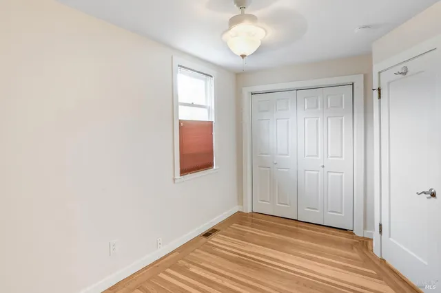 a view of a room with wooden floor and bathroom
