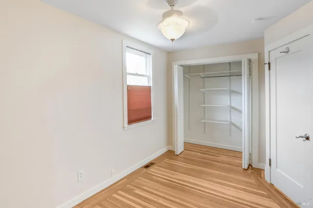 a view of a room with wooden floor and closet