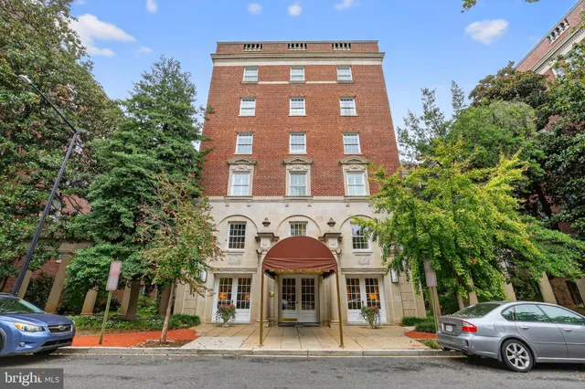 a front view of a residential apartment building with a yard