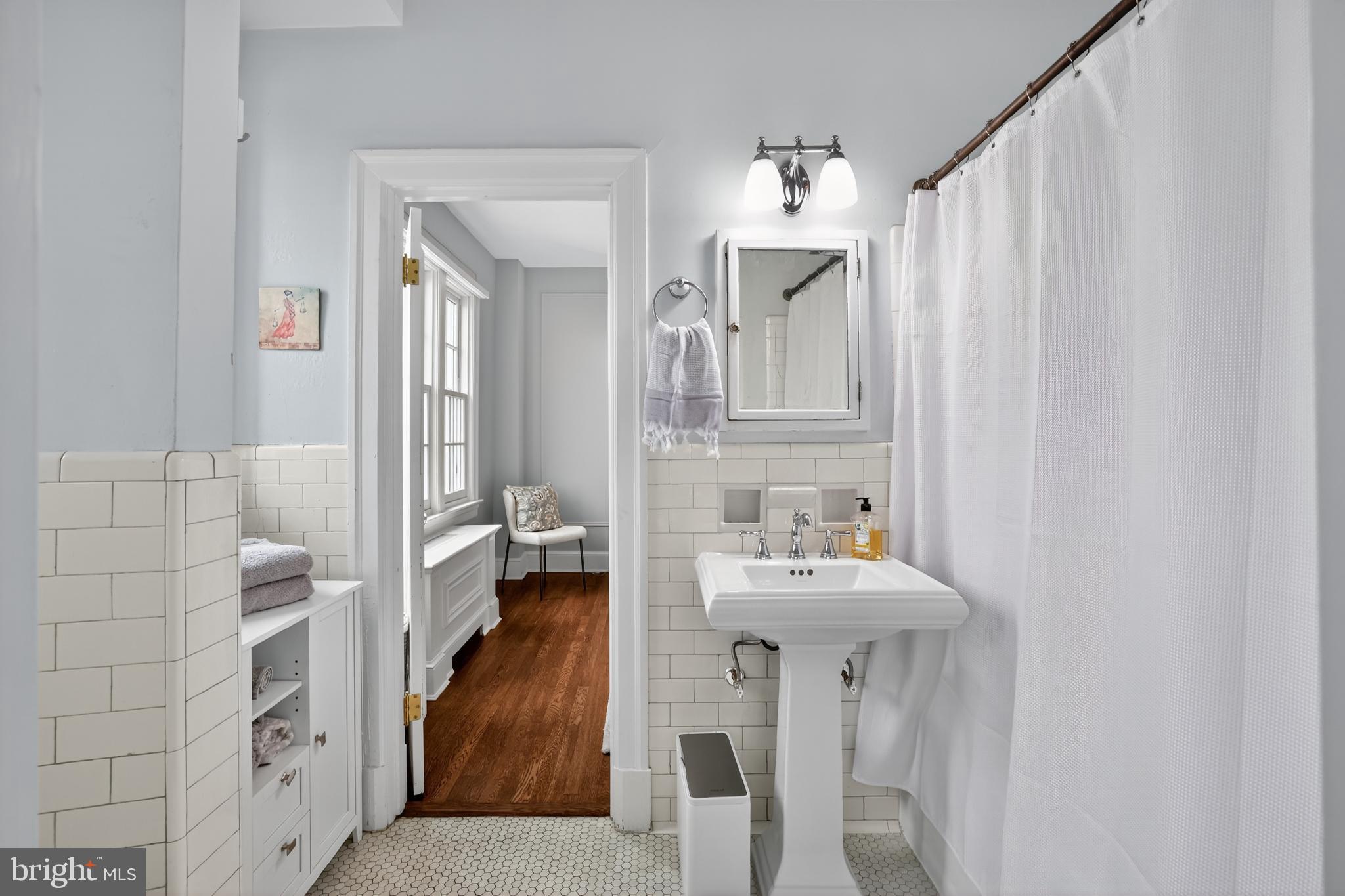 1661 Crescent Place Northwest, Unit 604 Washington, DC 20009 - Photo 23 of 61 a en suite bathroom with a sink and a mirror