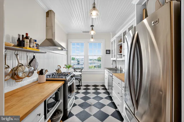 a kitchen with stainless steel appliances granite countertop a stove and a refrigerator