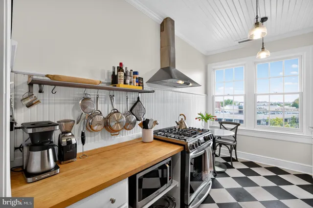 a kitchen with stainless steel appliances granite countertop a stove and a refrigerator