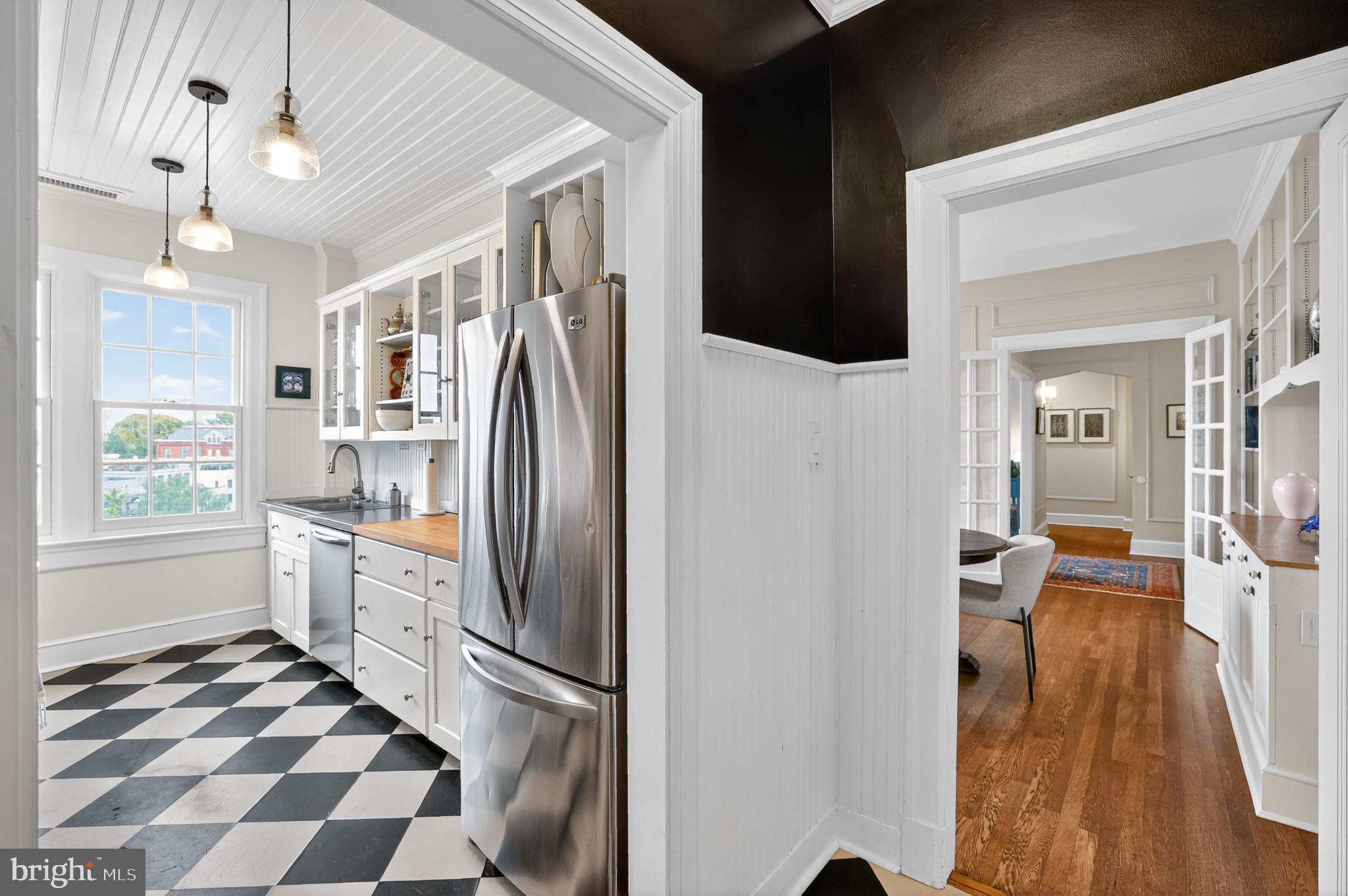 1661 Crescent Place Northwest, Unit 604 Washington, DC 20009 - Photo 39 of 61 a kitchen with granite countertop stainless steel appliances a sink and a refrigerator