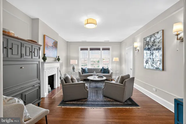 a living room with fireplace furniture and a window