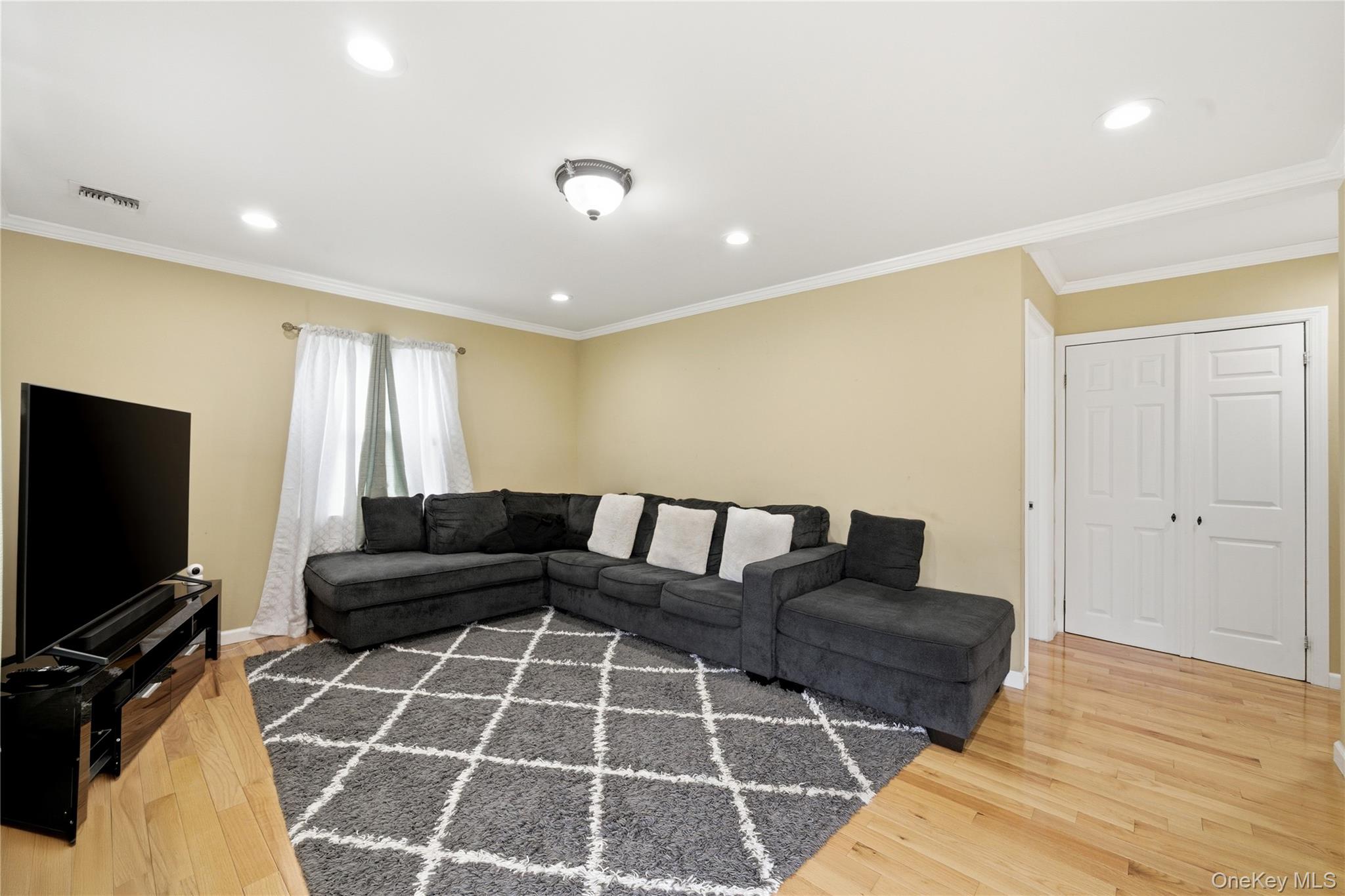 50 Ridge Lane Levittown, NY 11756 - Photo 6 of 27 a living room with furniture and a flat screen tv