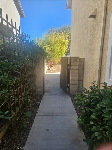 a view of a pathway of a house with a small yard
