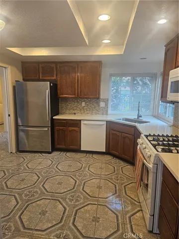 a kitchen with stainless steel appliances granite countertop a sink and cabinets