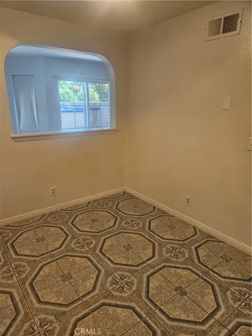 a kitchen with granite countertop a sink a stove a refrigerator and cabinets