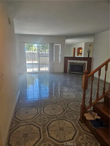 a living room with hard wood floors and a wooden floor