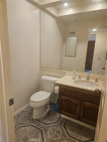 a bathroom with a sink toilet and mirror