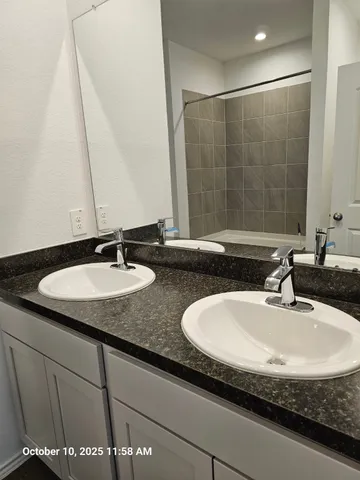 a bathroom with a granite countertop sink and a mirror