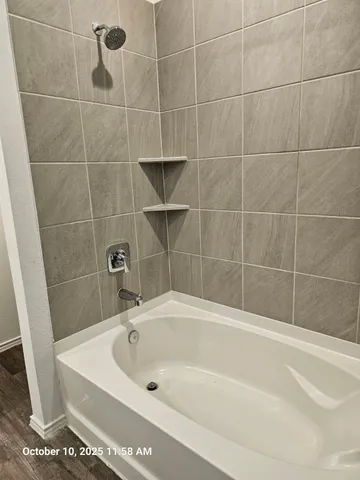a white bath tub sitting next to a blue sink