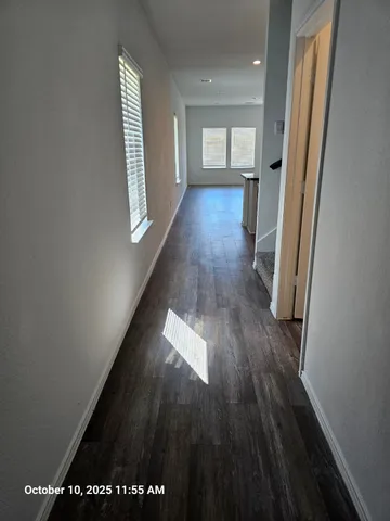 a view of gallery with wooden floor
