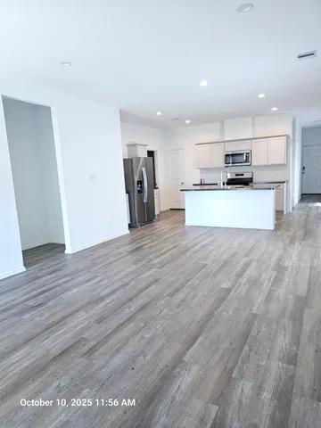 a view of kitchen with refrigerator microwave and stove