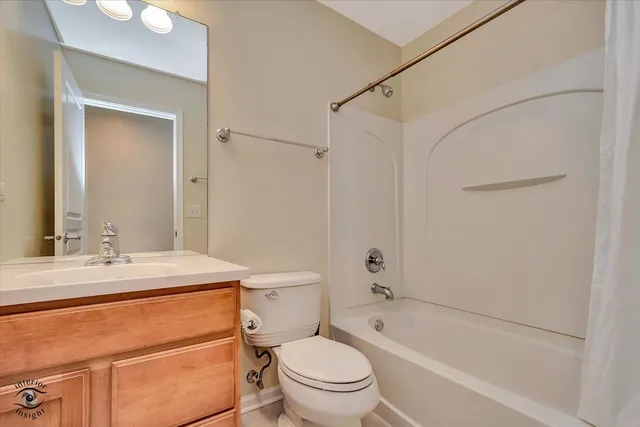 a bathroom with a sink toilet vanity and shower