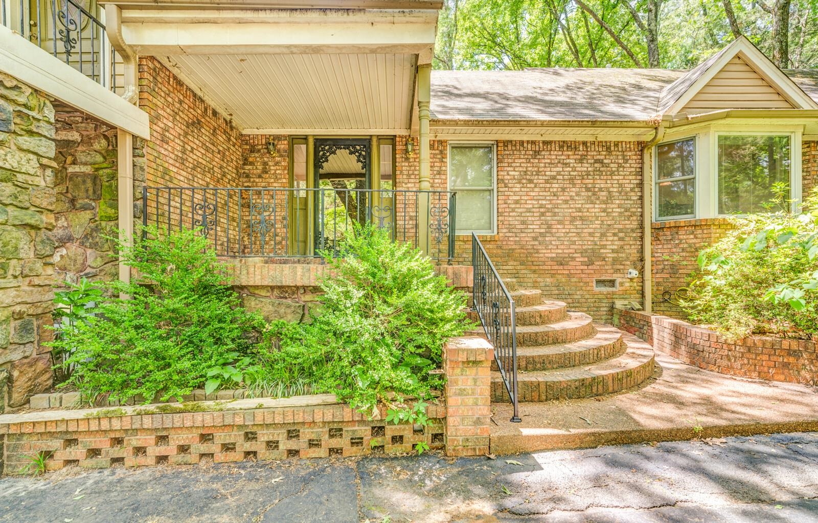 8651 Baylor Road Bartlett, TN 38002 - Photo 2 of 29 a view of a brick house with plants