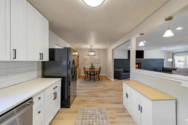 a kitchen with stainless steel appliances a refrigerator and a stove top oven