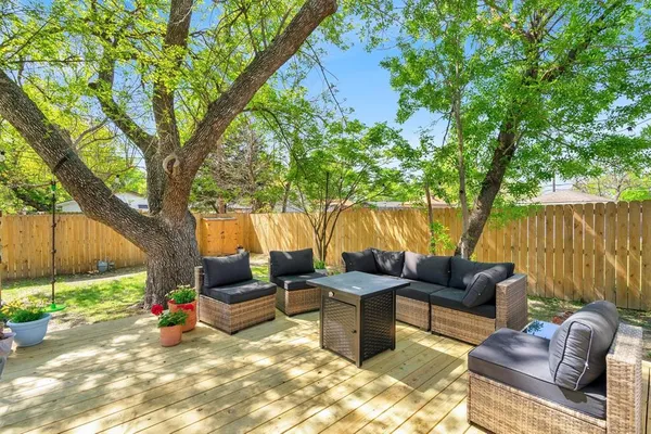 a view of a patio with couches chairs and a potted plant