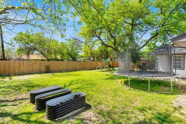 a front view of a house with a garden and yard