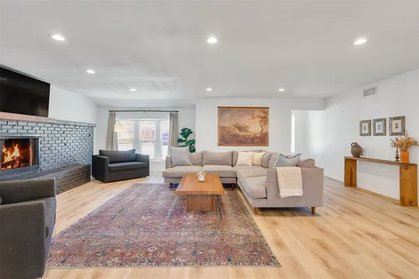 a living room with furniture fireplace and a flat screen tv