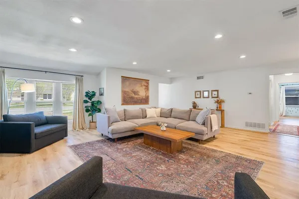 a living room with furniture and wooden floor