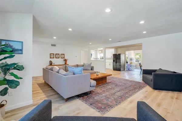a living room with furniture and wooden floor