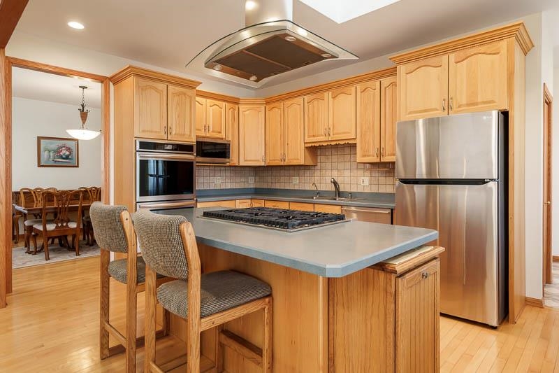 19905 State Line Road Harvard, IL 60033 - Photo 11 of 55 a kitchen with stainless steel appliances granite countertop a stove refrigerator sink and cabinets
