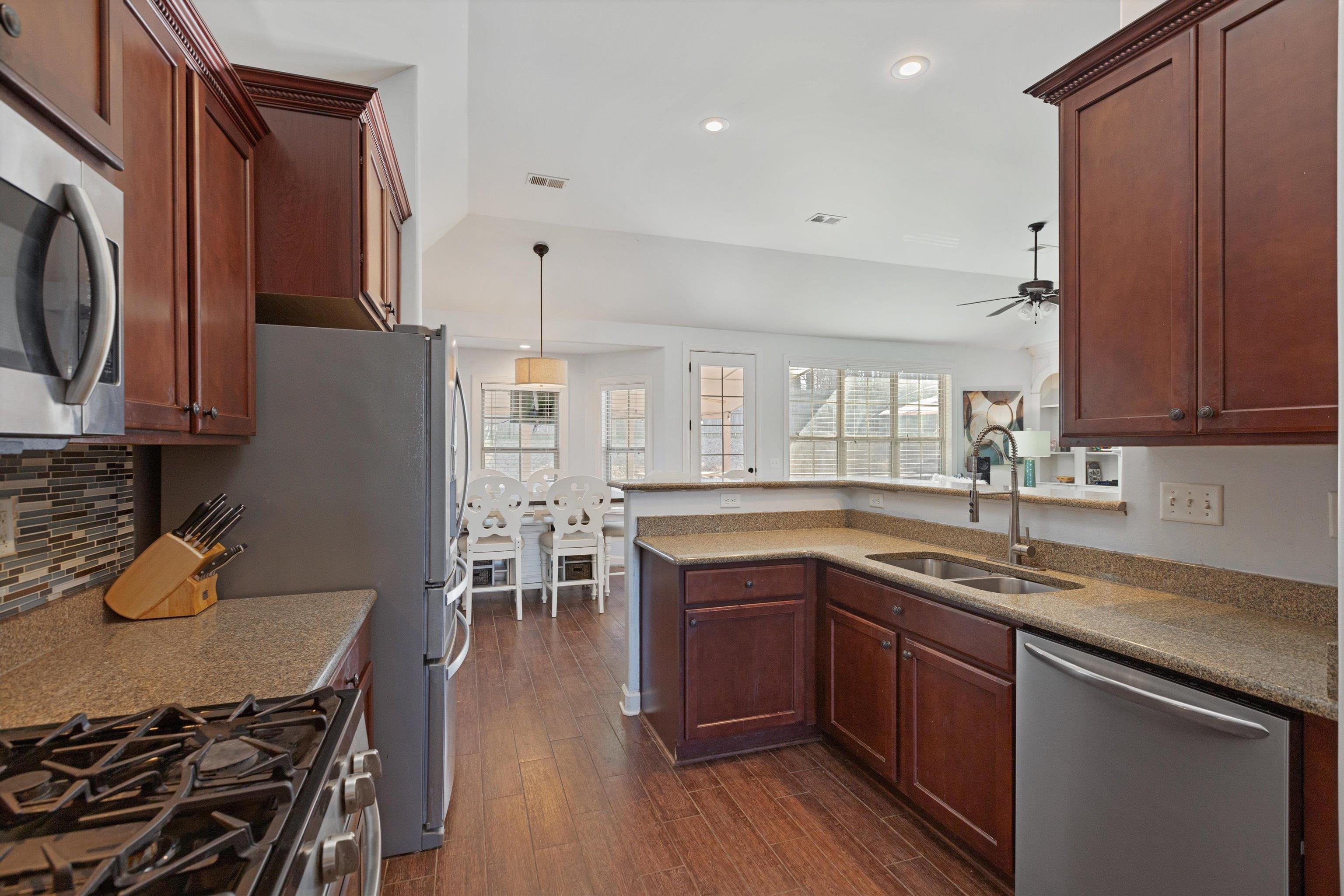 6005 Maher Valley Cove Bartlett, TN 38135 - Photo 13 of 28 a kitchen with stainless steel appliances granite countertop a sink stove and refrigerator