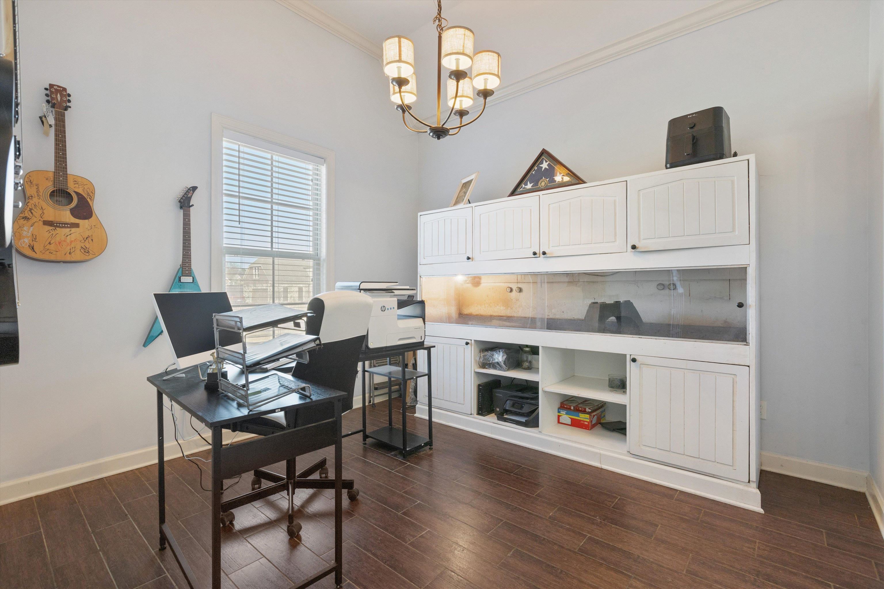 6005 Maher Valley Cove Bartlett, TN 38135 - Photo 17 of 28 a kitchen with stainless steel appliances a stove a sink dishwasher a dining table and chairs with wooden floor