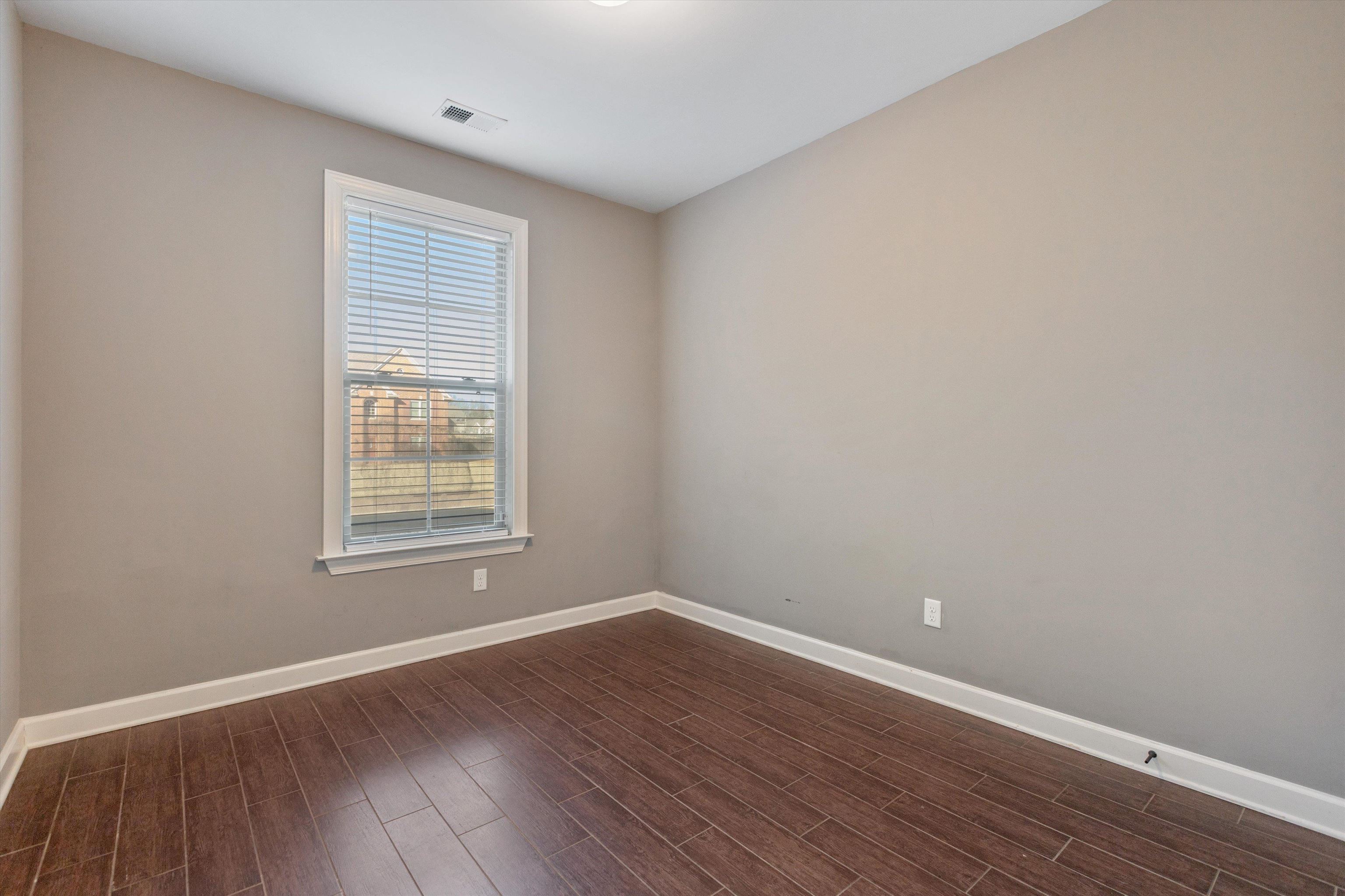 6005 Maher Valley Cove Bartlett, TN 38135 - Photo 19 of 28 an empty room with wooden floor and windows