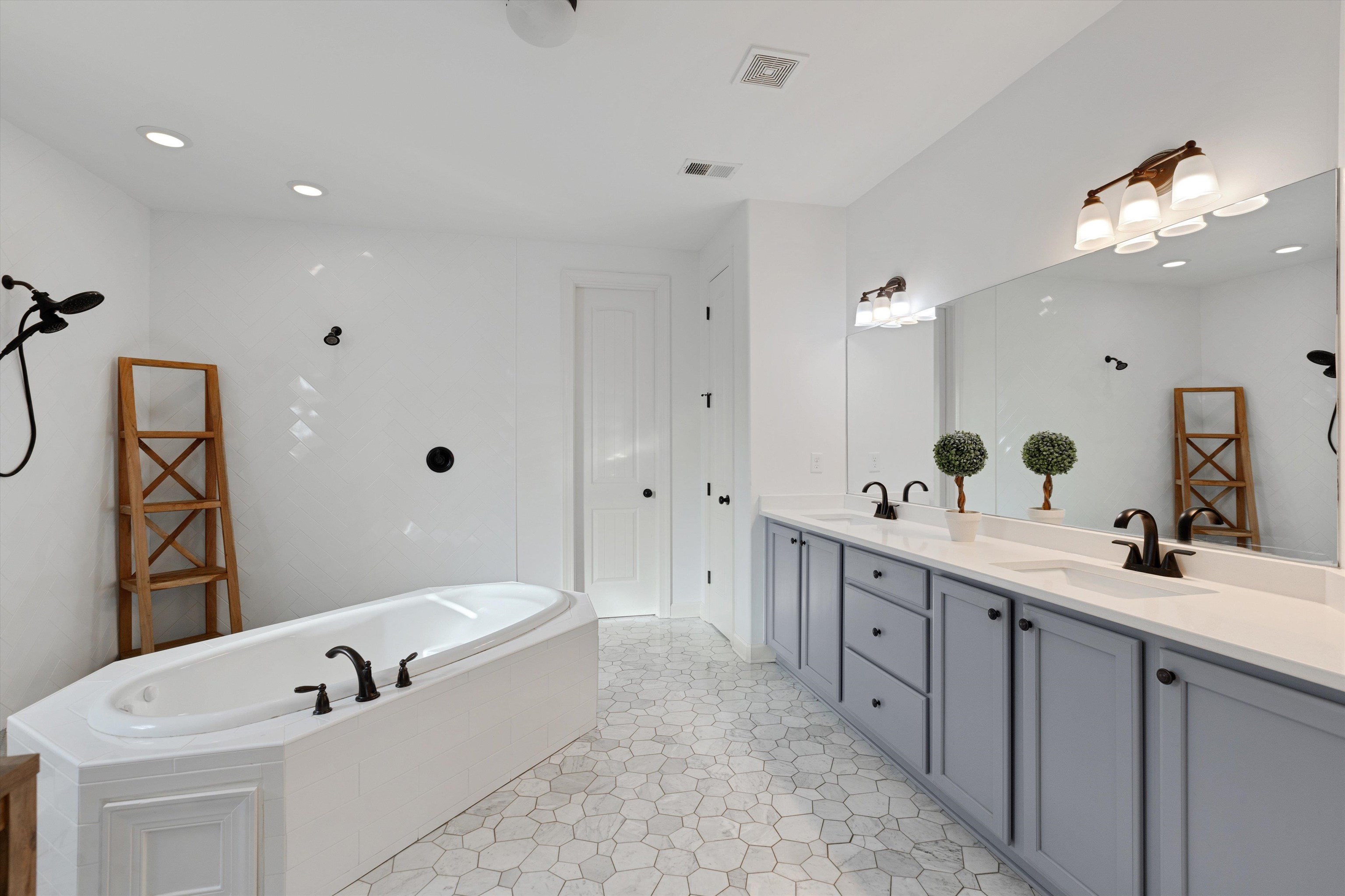 6005 Maher Valley Cove Bartlett, TN 38135 - Photo 2 of 28 a bathroom with a double vanity sink mirror and bathtub