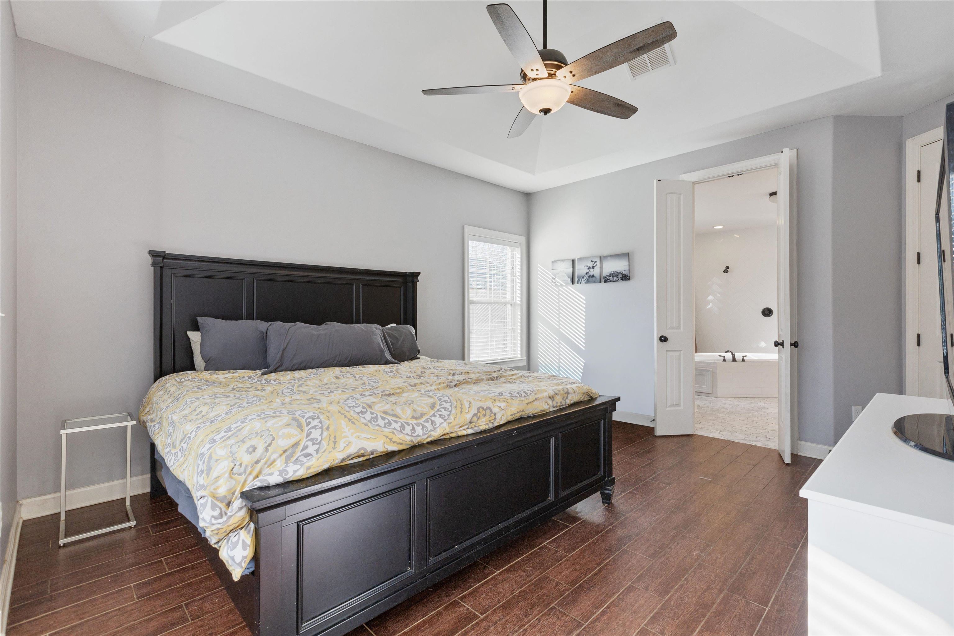 6005 Maher Valley Cove Bartlett, TN 38135 - Photo 5 of 28 a bedroom with a bed and a chandelier