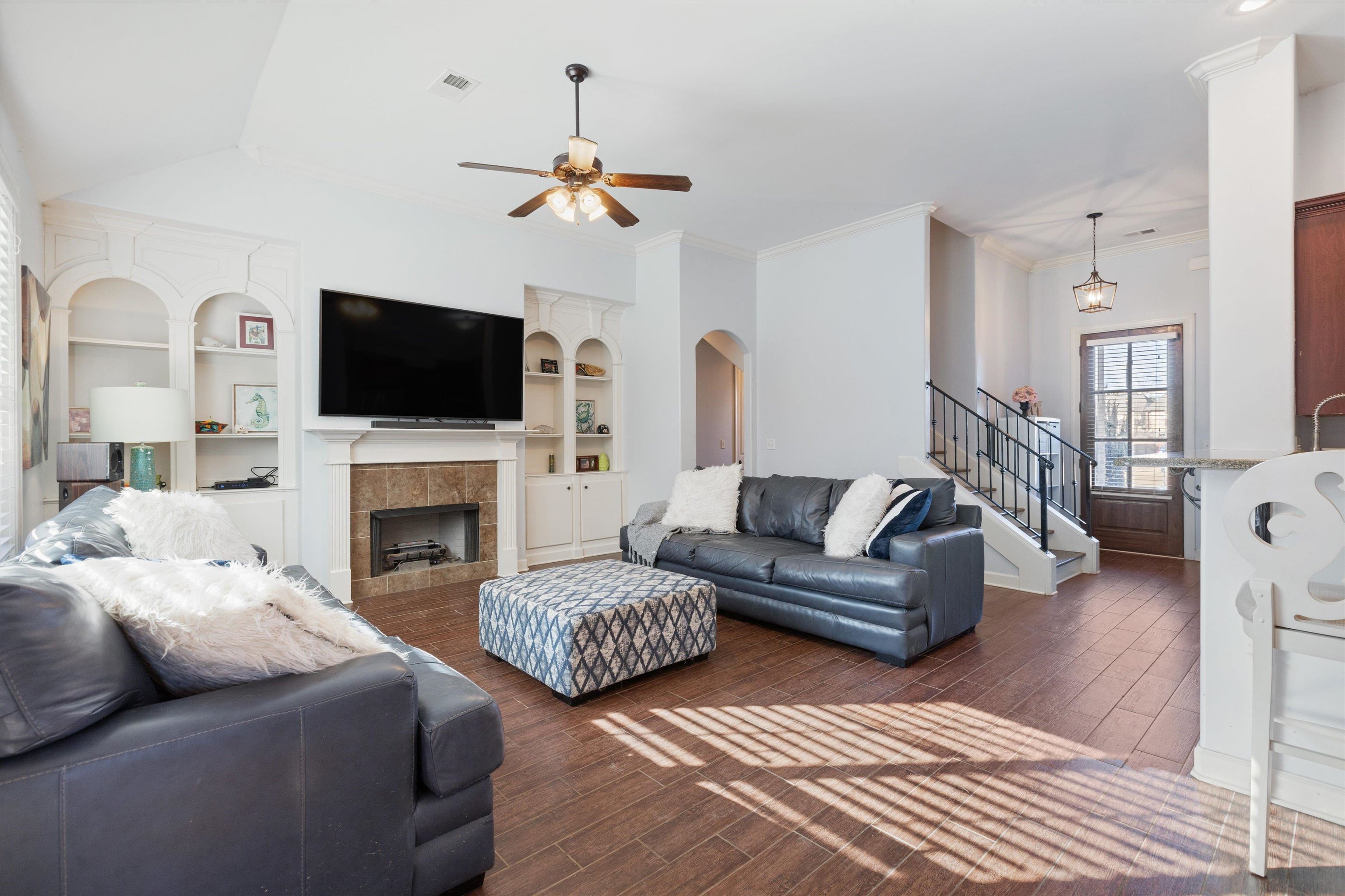 6005 Maher Valley Cove Bartlett, TN 38135 - Photo 7 of 28 a living room with couches a fireplace and a flat screen tv
