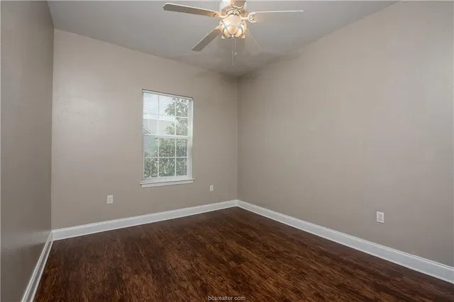 a view of wooden floor and windows in a room