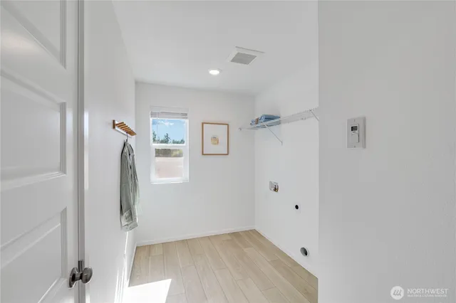 a view of a hallway with entryway with wooden floor