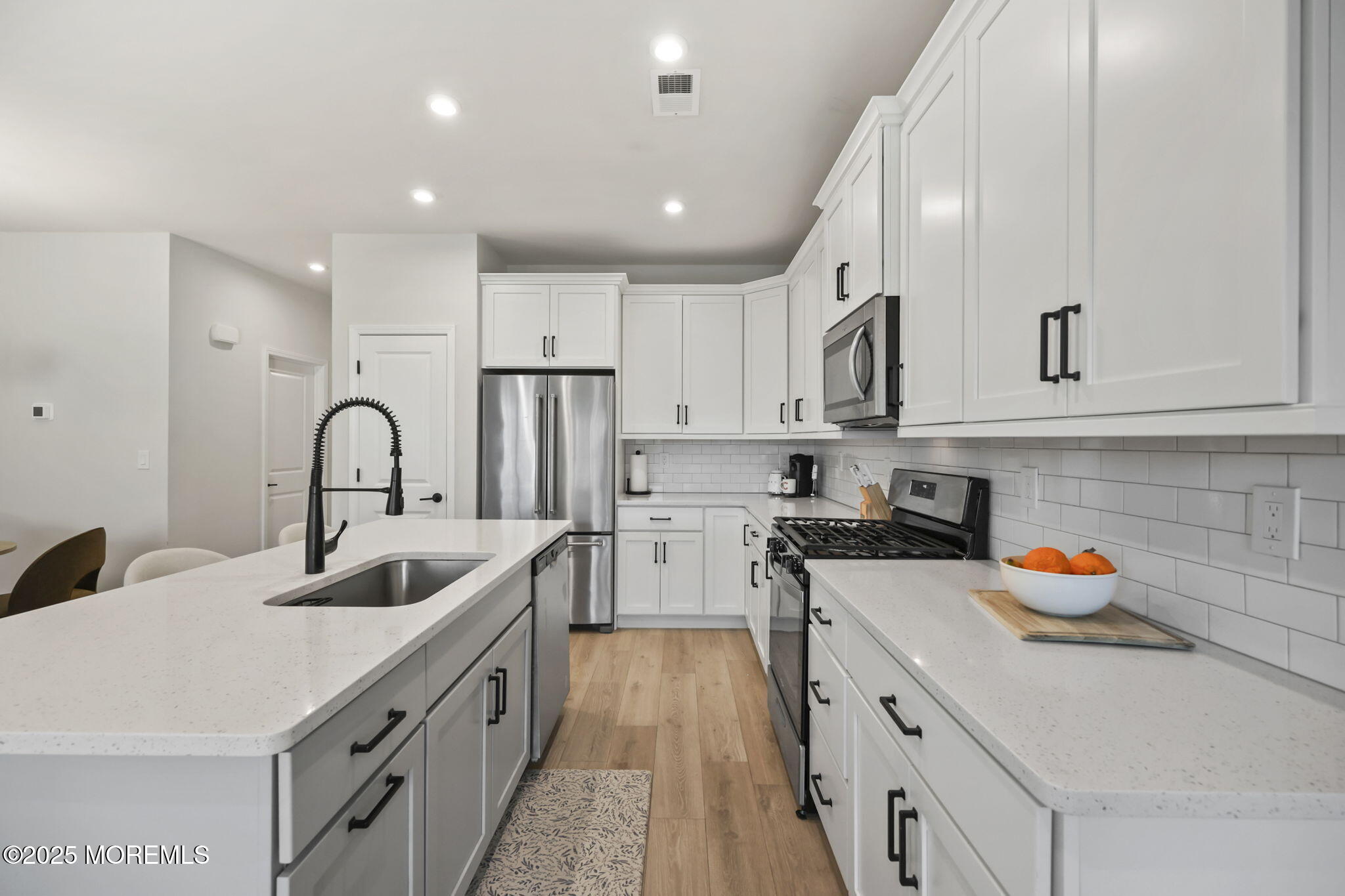16 Chapel Lane Neptune, NJ 07753 - Photo 11 of 26 a kitchen with stainless steel appliances granite countertop a sink stove and cabinets