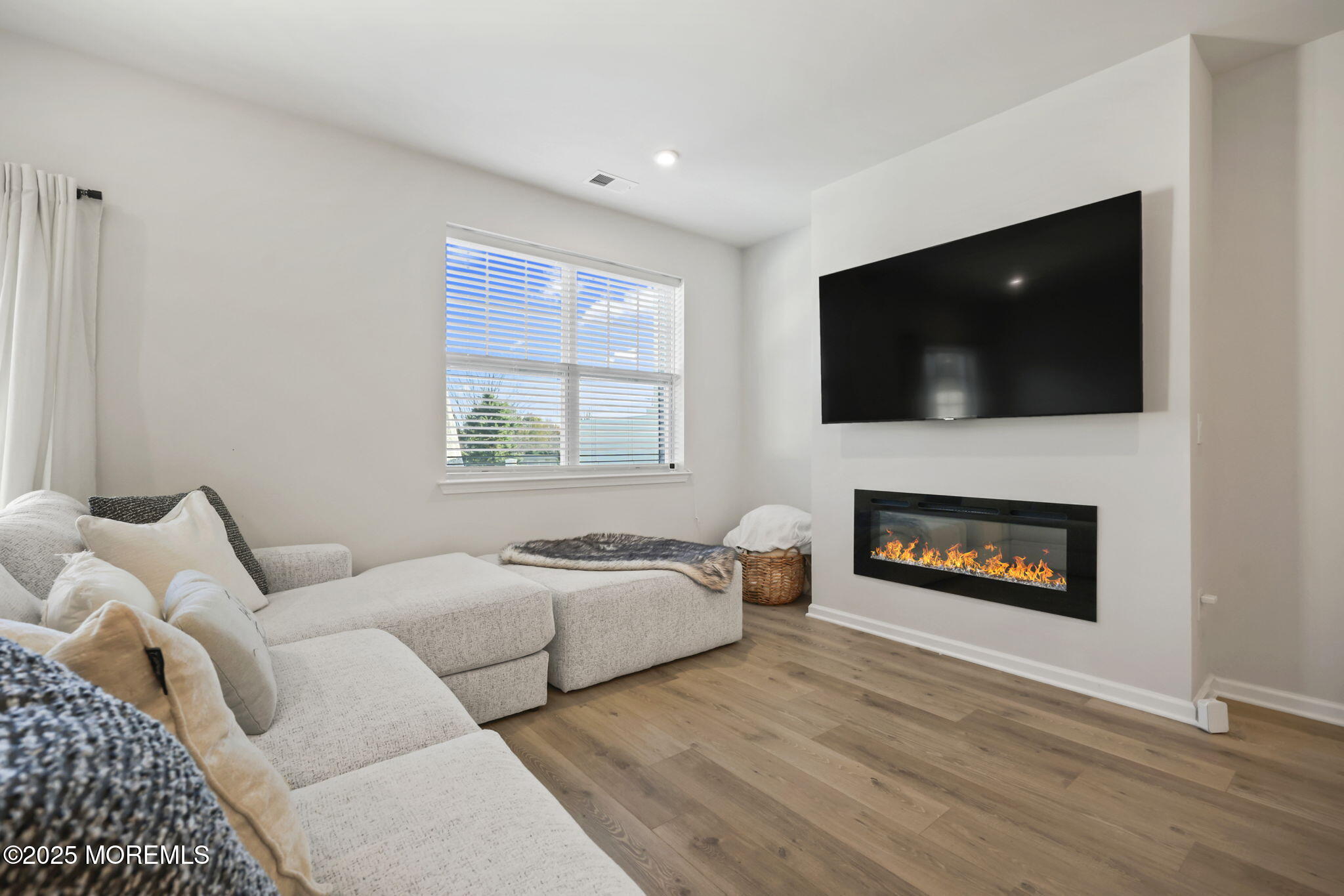 16 Chapel Lane Neptune, NJ 07753 - Photo 13 of 26 a living room with furniture a flat screen tv and a fireplace
