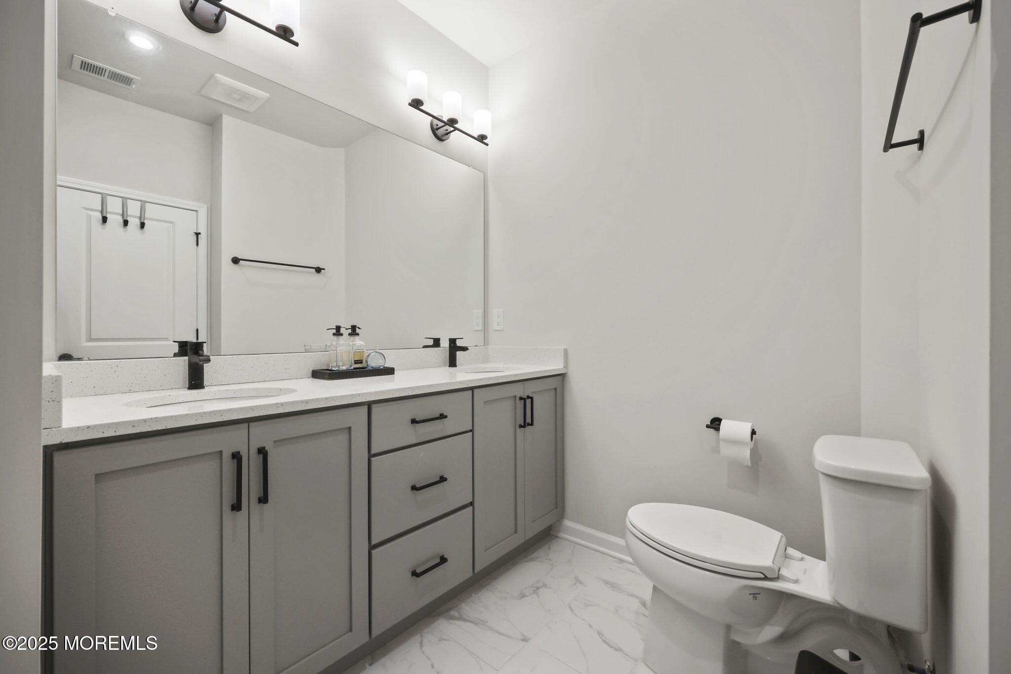 16 Chapel Lane Neptune, NJ 07753 - Photo 20 of 26 a bathroom with a double vanity sink toilet and a mirror