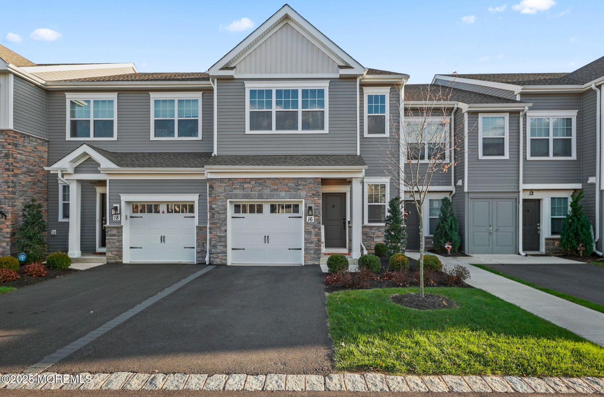 16 Chapel Lane Neptune, NJ 07753 - Photo 2 of 26 a front view of a house with a yard and garage