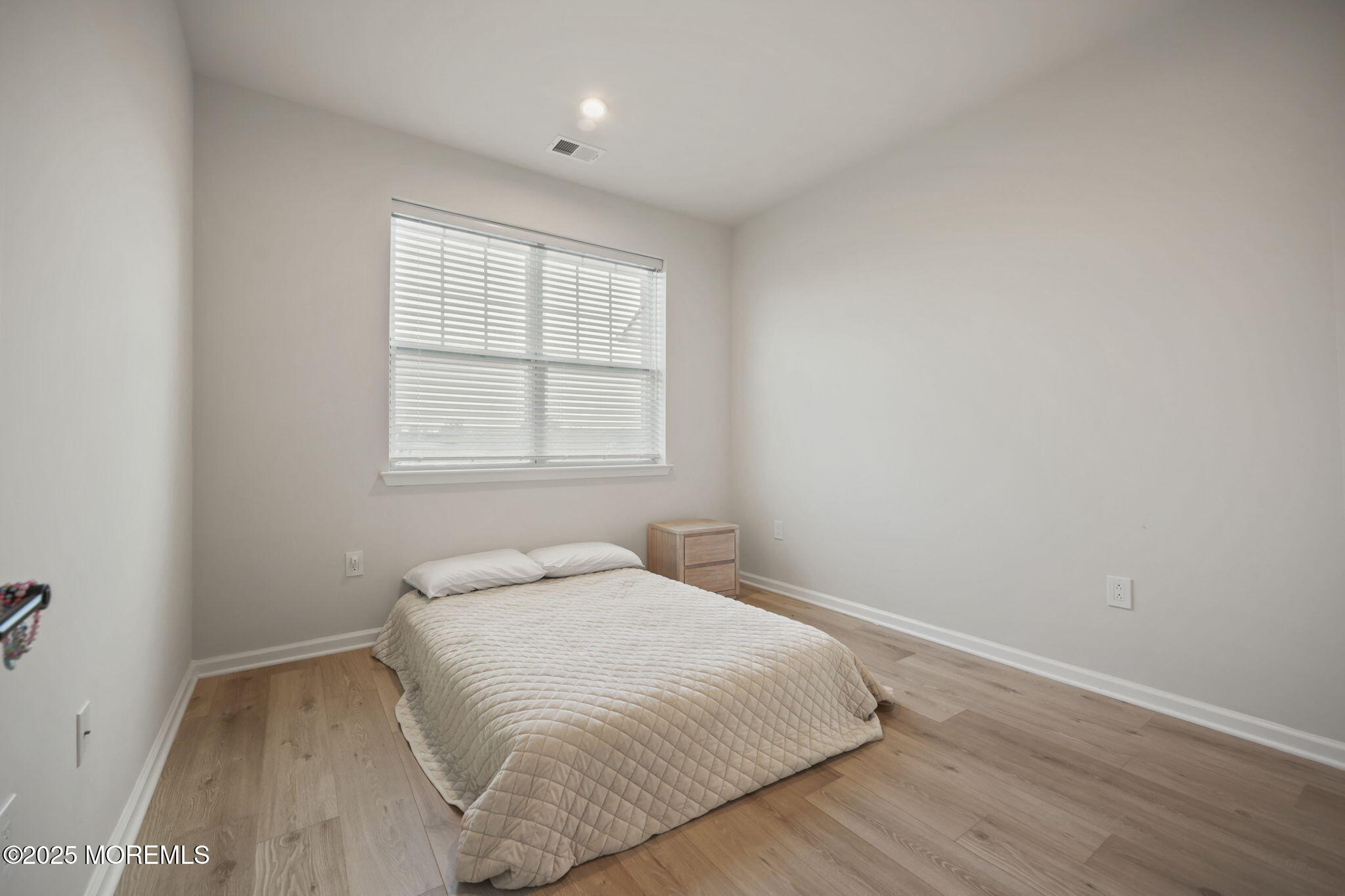 16 Chapel Lane Neptune, NJ 07753 - Photo 23 of 26 a bedroom with a bed and a window
