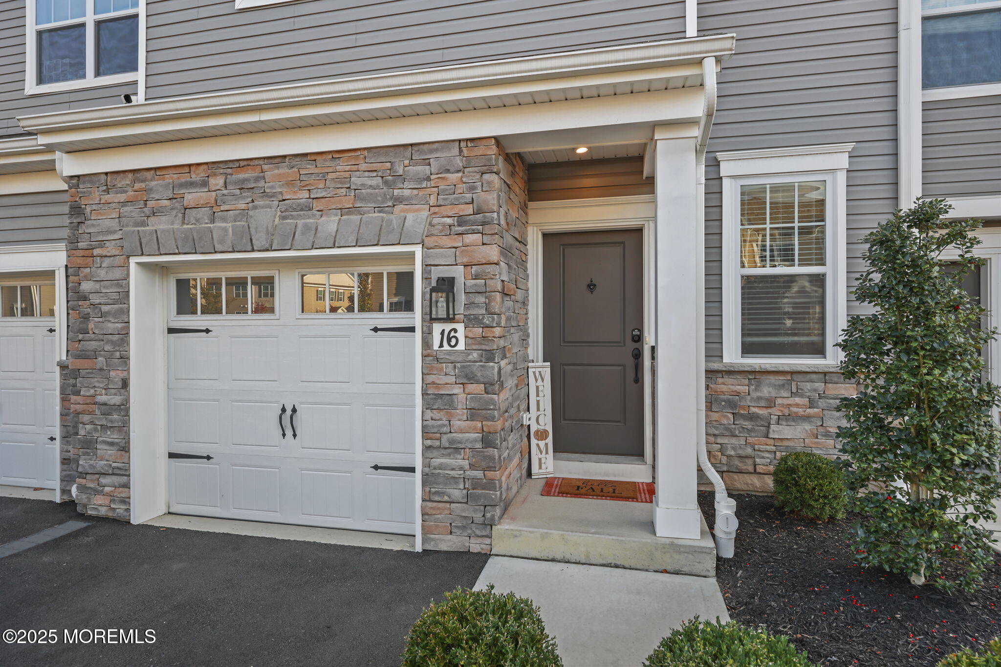 16 Chapel Lane Neptune, NJ 07753 - Photo 4 of 26 a front view of a house with a garage