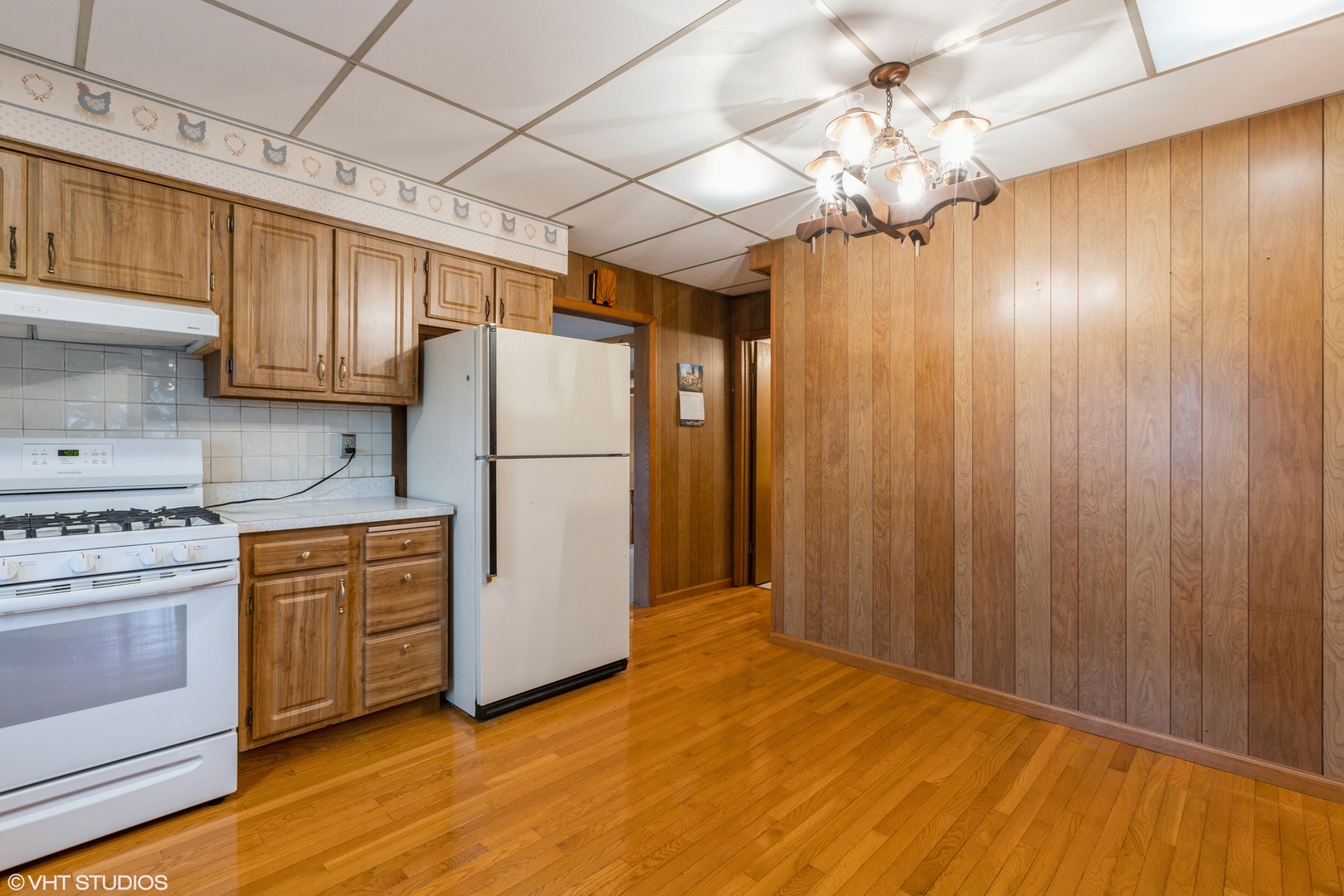 6222 Rich Road DeKalb, IL 60115 - Photo 7 of 31 a kitchen with cabinets appliances and a wooden floor