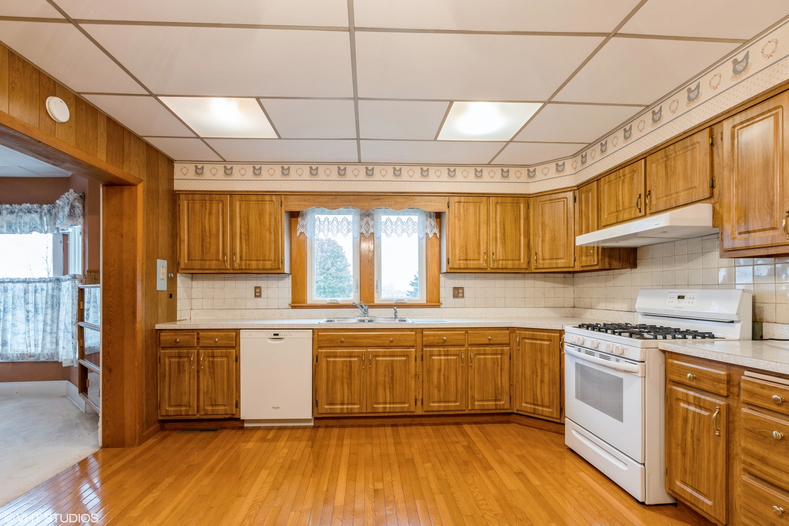 6222 Rich Road DeKalb, IL 60115 - Photo 8 of 31 a kitchen with stainless steel appliances granite countertop a white cabinets and wooden floor