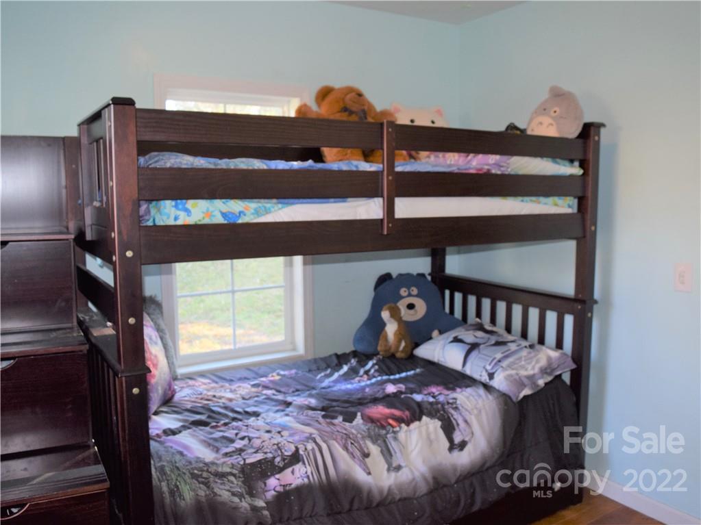 133 Substation Road Canton, NC 28716 - Photo 5 of 8 a bedroom with a bed and window