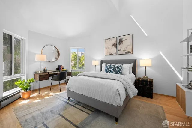 a bedroom with a bed and a chandelier