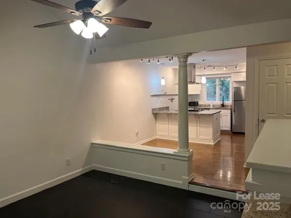 a view of kitchen with refrigerator and window