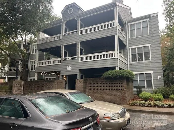 a view of a house with a small yard and swimming pool