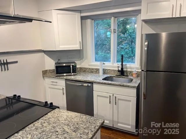 a kitchen with a sink and a refrigerator
